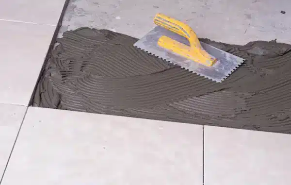 Tile adhesive and trowel